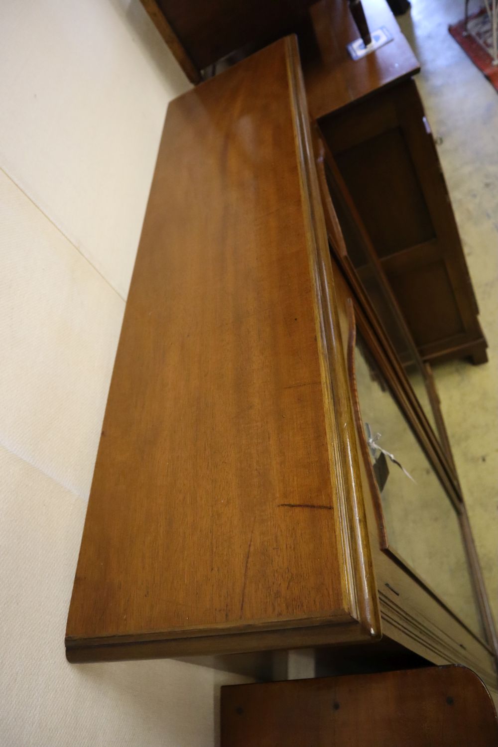 A late Victorian walnut two door glazed bookcase, width 102cm, depth 28cm, height 128cm